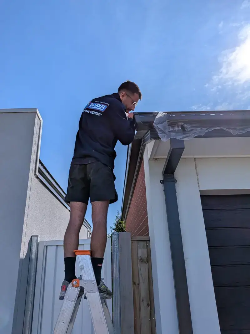 Roof plumber working on gutter in Toorak